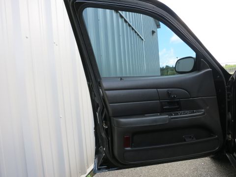 2001 Ford Crown Victoria - Interior view of the driver's side door panel and window of a 2001 Ford Crown Victoria.