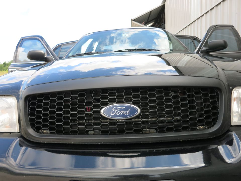 Black Ford Crown Victoria grille with honeycomb pattern and Ford oval badge