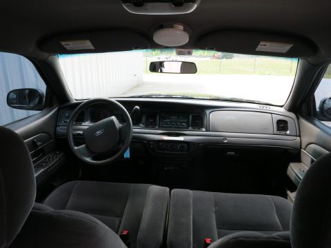 2001 Ford Crown Victoria - The interior of a 2001 Ford Crown Victoria is viewed from the back seat, looking towards the dashboard.