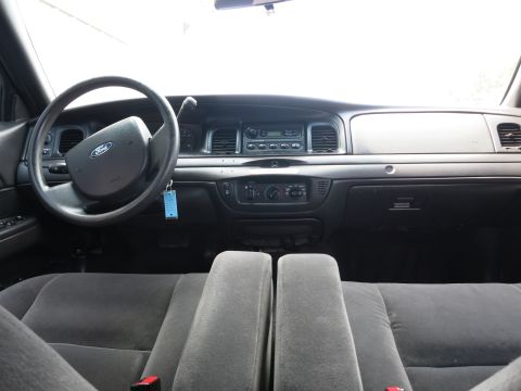 2001 Ford Crown Victoria - The interior of a 2001 Ford Crown Victoria shows the dashboard, steering wheel, and front seats.