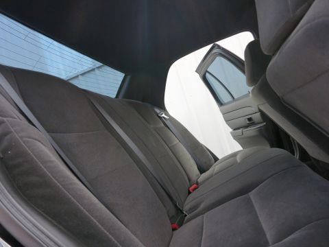 2001 Ford Crown Victoria - Interior view of the rear seats and door panel of a car.
