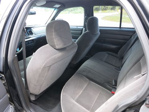 2001 Ford Crown Victoria - Interior view of gray cloth seats and dashboard in a black car.