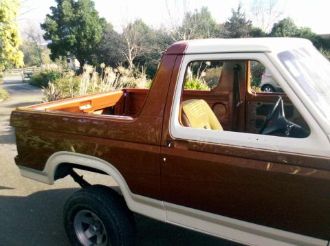 1982 Ford Bronco - Side view of a 1982 Ford Bronco, highlighting its distinct body style and two-tone paint.