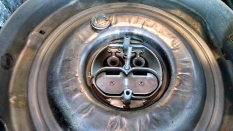 1979 Ford F-150 - Close-up of a dual snorkel air cleaner assembly, showing internal carburetor parts and a metal cap.