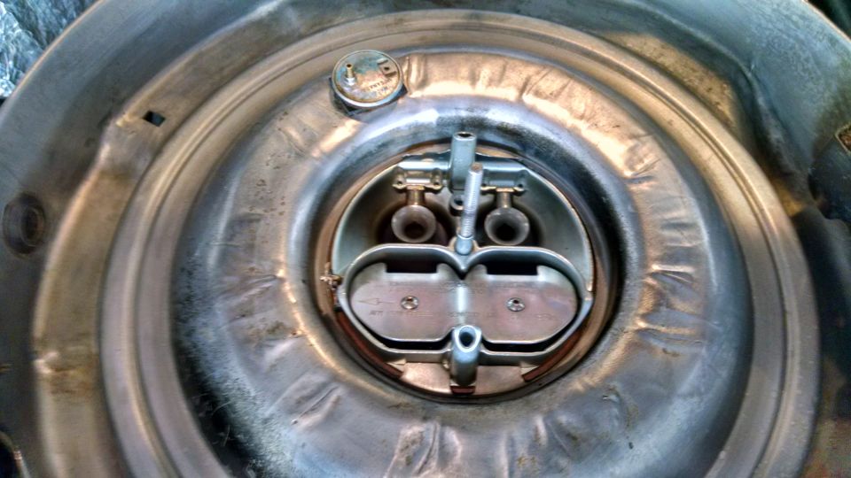 Metal dual snorkel air cleaner assembly with visible carburetor components and a small cap with text