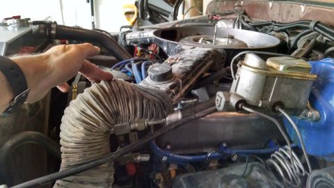 1979 Ford F-150 - Close-up of engine bay components, including a flexible air intake hose and brake master cylinder.