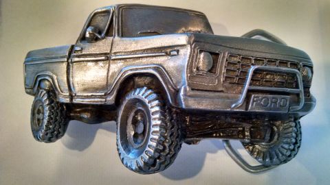 1979 Ford F-150 - This silver belt buckle features a detailed replica of a Ford F-150 truck's front end.