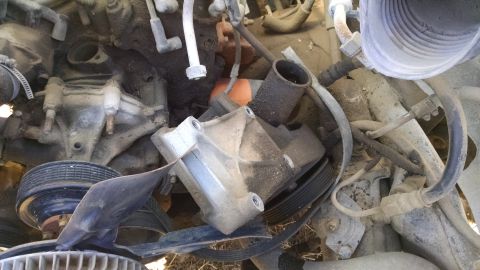 1979 Ford F-150 - Close-up view of engine components, including a water pump bracket and pulleys.
