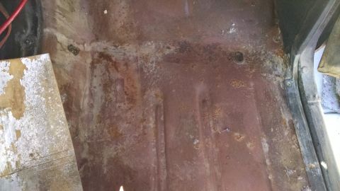 1979 Ford F-150 - Rusted floor pan showing significant corrosion and wear.
