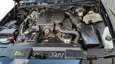 2001 Ford Crown Victoria - Engine bay of a 2001 Ford Crown Victoria, showing the V8 engine and associated components.