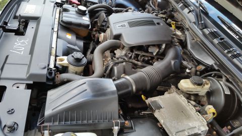 2001 Ford Crown Victoria - Close-up view of a vehicle's engine compartment, showing various mechanical parts and wiring harnesses.