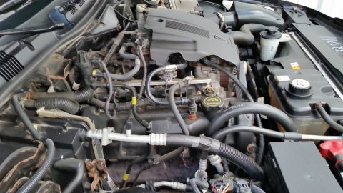 2001 Ford Crown Victoria - The engine bay of a 2001 Ford Crown Victoria is visible, with various mechanical parts and wiring.