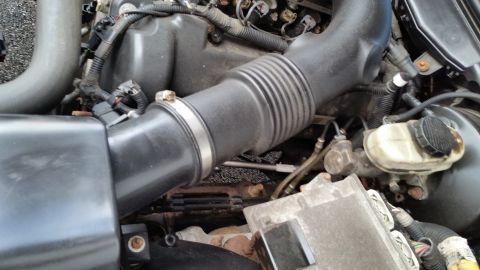 2001 Ford Crown Victoria - Close-up view of the engine bay, showing the air intake system and brake fluid reservoir.