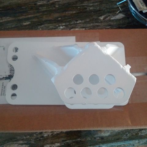 1978 Ford Bronco - A white metal skid plate with multiple circular holes is shown, likely a replacement part.