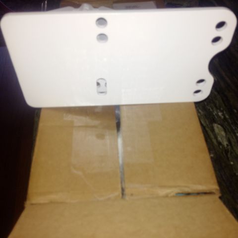 1978 Ford Bronco - A white suspension component is shown, positioned above cardboard packaging.