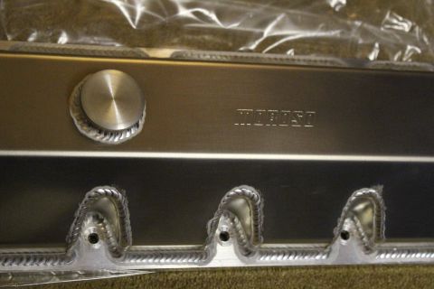 2003 Ford Crown Victoria - Close-up of a fabricated aluminum valve cover showing the filler cap, a Moroso stamp, and rope-welded bolt bosses.