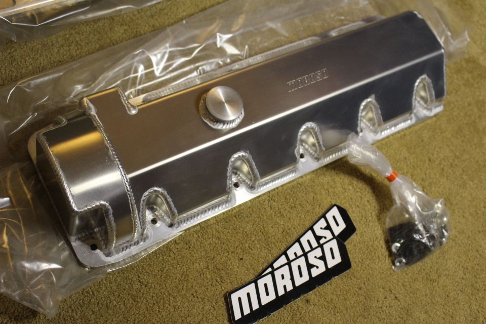 Wrapped fabricated aluminum valve cover with filler cap above a black Moroso badge