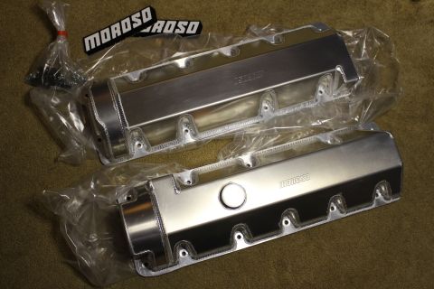2003 Ford Crown Victoria - pair of fabricated aluminum valve covers in plastic wrap, one with a filler cap, displayed near black Moroso badges.
