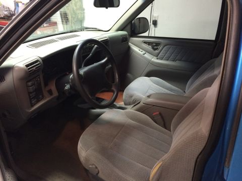 1995 Chevrolet Blazer - The interior of a 1995 Chevrolet Blazer, cloth seats and a blue exterior.