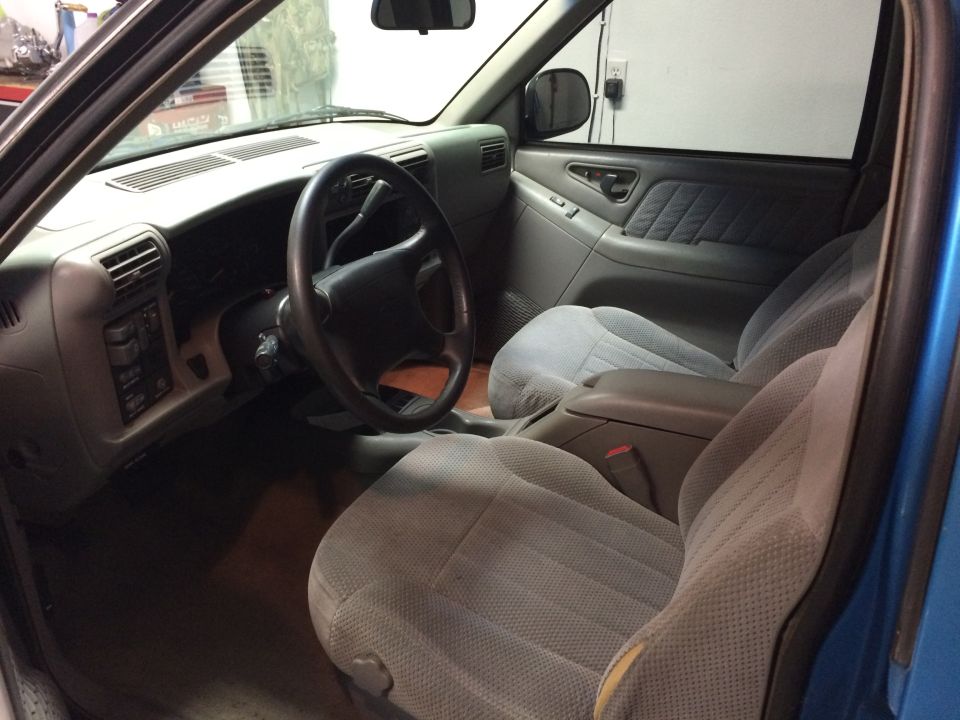 Interior of a 1995 Chevrolet Blazer, showing dashboard, steering wheel, and seats