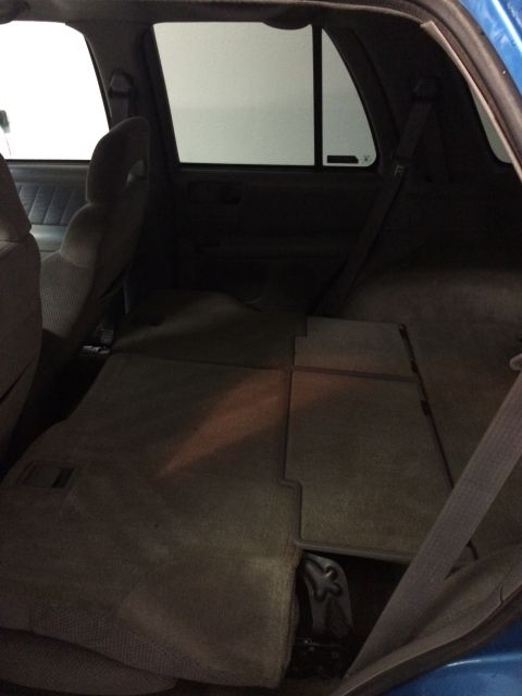 1995 Chevrolet Blazer - Interior view of a blue SUV, showing the folded rear seats and cargo area.