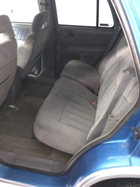 1995 Chevrolet Blazer - Interior view of the rear seats and door panel of a blue SUV.