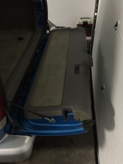 1995 Chevrolet Blazer - Interior view of the rear cargo area with the door open, showing the trim panel.