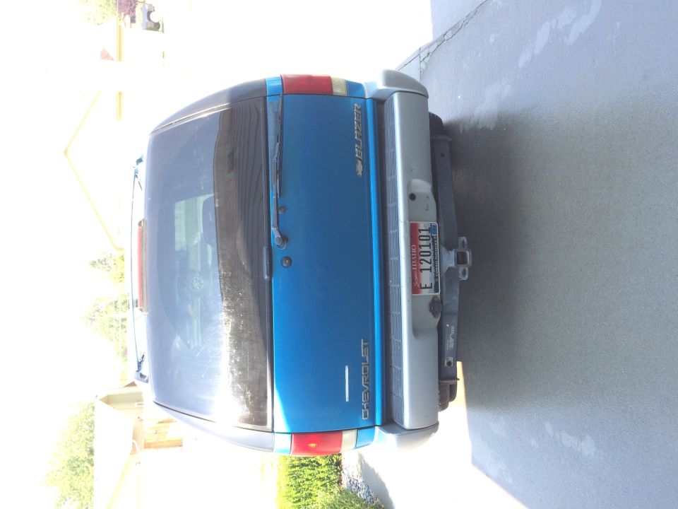 Blue 1995 Chevrolet Blazer SUV rear view, silver bumper, Idaho license plate E 120101