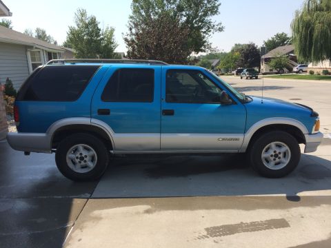 1995 Chevrolet Blazer - Side view of a 1995 Chevrolet Blazer SUV with a two-tone blue and silver paint scheme.