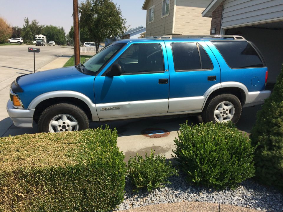 1995 Chevrolet Blazer, blue with silver lower body trim, parked on driveway
