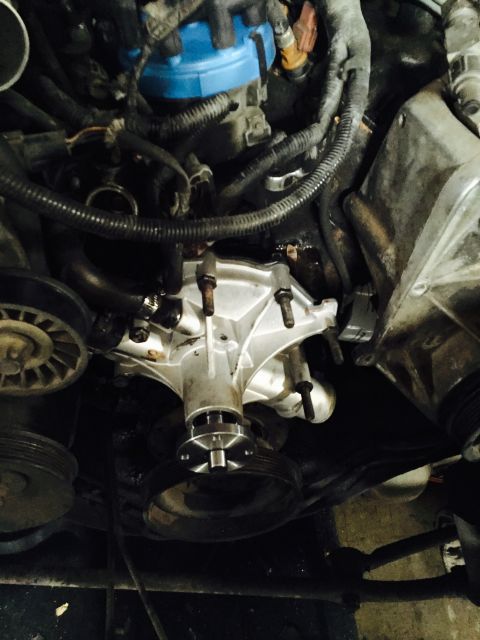 1988 Ford Bronco - Close-up view of a vehicle's engine, focusing on the water pump and associated components.