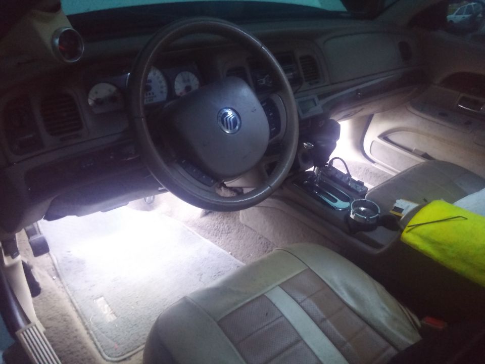 Interior of a 2000 Mercury Grand Marquis showing the dashboard, steering wheel, and seats