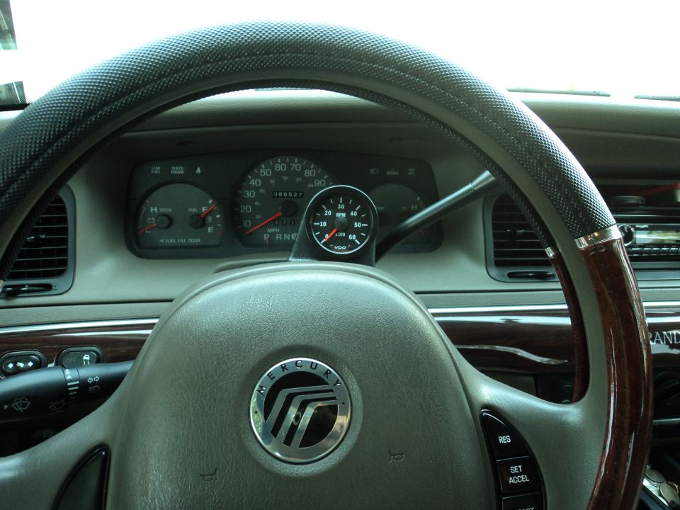 Dashboard of a 2004 Mercury Grand Marquis with a tachometer mounted on the steering column