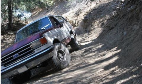 1990 Ford Bronco - This 1990 Ford Bronco navigates a challenging off-road trail.