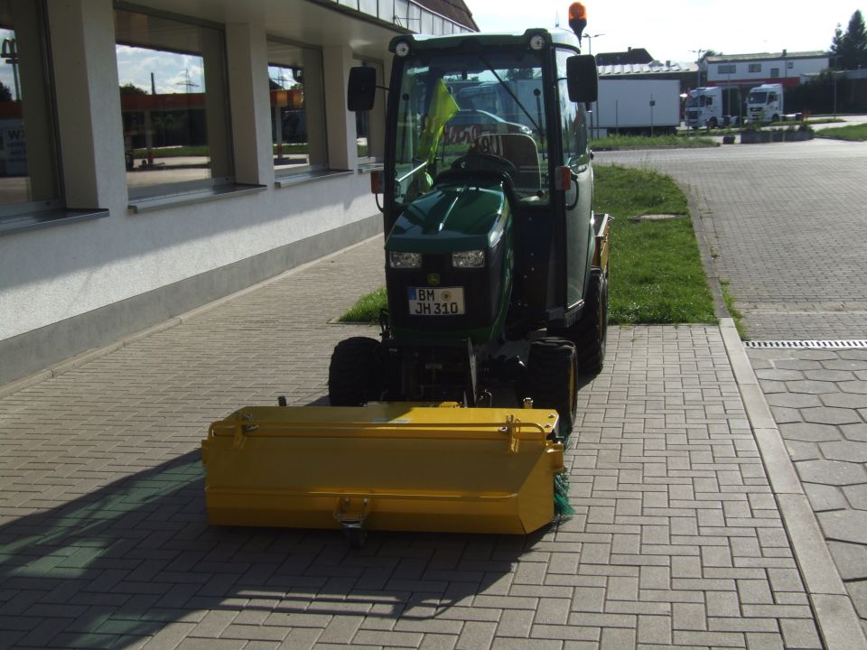 Green tractor with yellow front attachment and license plate BM JH310