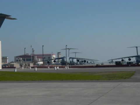 1990 Ford Bronco - Multiple large cargo aircraft are lined up on a sunny day at an airport.