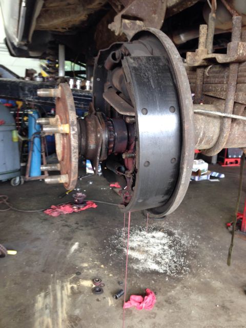 1979 Ford Bronco - The brake drum assembly is shown with the brake shoes and drum exposed, indicating a need for maintenance.