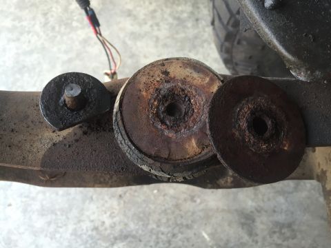 1978 Ford Bronco - Close-up of heavily rusted suspension parts, likely from an older vehicle's chassis.