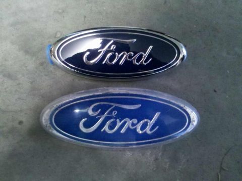 1982 Ford Bronco - Two Ford emblems are shown, one with a dark blue background and the other with a bright blue background.