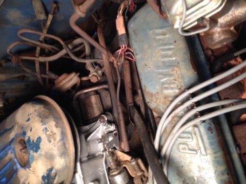 1973 Ford Bronco - Engine bay detail with carburetor and blue valve cover. Text on valve cover is partially visible.