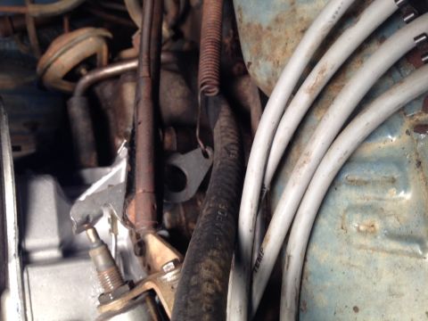 1973 Ford Bronco - A close-up view of various engine components, including spark plug wires and hoses, within an engine bay.