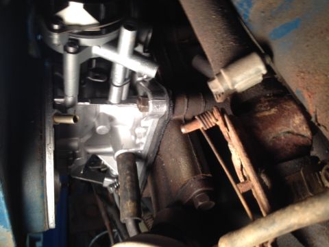 1973 Ford Bronco - Detail of engine components including carburetor and linkage, with visible signs of wear and rust.