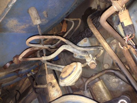 1973 Ford Bronco - Close-up view of engine bay components, including fuel lines and wiring harnesses.