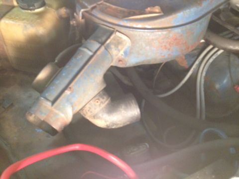 1973 Ford Bronco - Close-up view of an engine bay, a blue air cleaner housing and various hoses and wires.