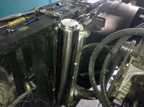 1982 Ford Bronco - Tools are laid out in the engine bay next to a chrome overflow tank.
