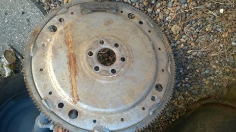 1994 Ford Bronco - A rusty flywheel, a component of a vehicle's engine, is shown from a top-down perspective.