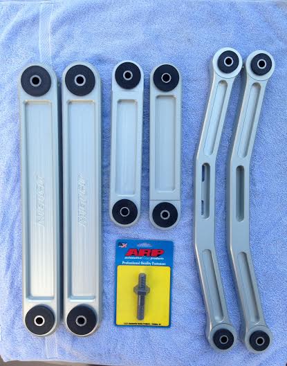 2004 Ford Crown Victoria - Several automotive suspension components, including control arms and a bolt kit, are laid out on a towel.