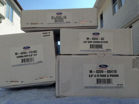 2004 Ford Crown Victoria - Several boxes of Ford Racing differential parts are stacked and displayed outdoors.