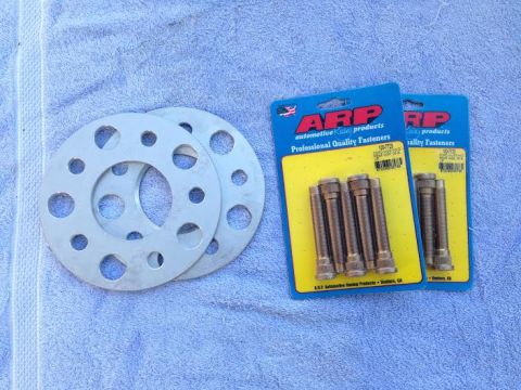 2004 Ford Crown Victoria - ARP automotive products professional quality fasteners and wheel spacers are laid out on a towel.