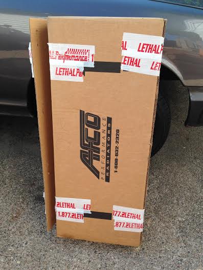 2004 Ford Crown Victoria - A cardboard box for AFCO Performance Radiators is shown, taped with Lethal Performance branding.